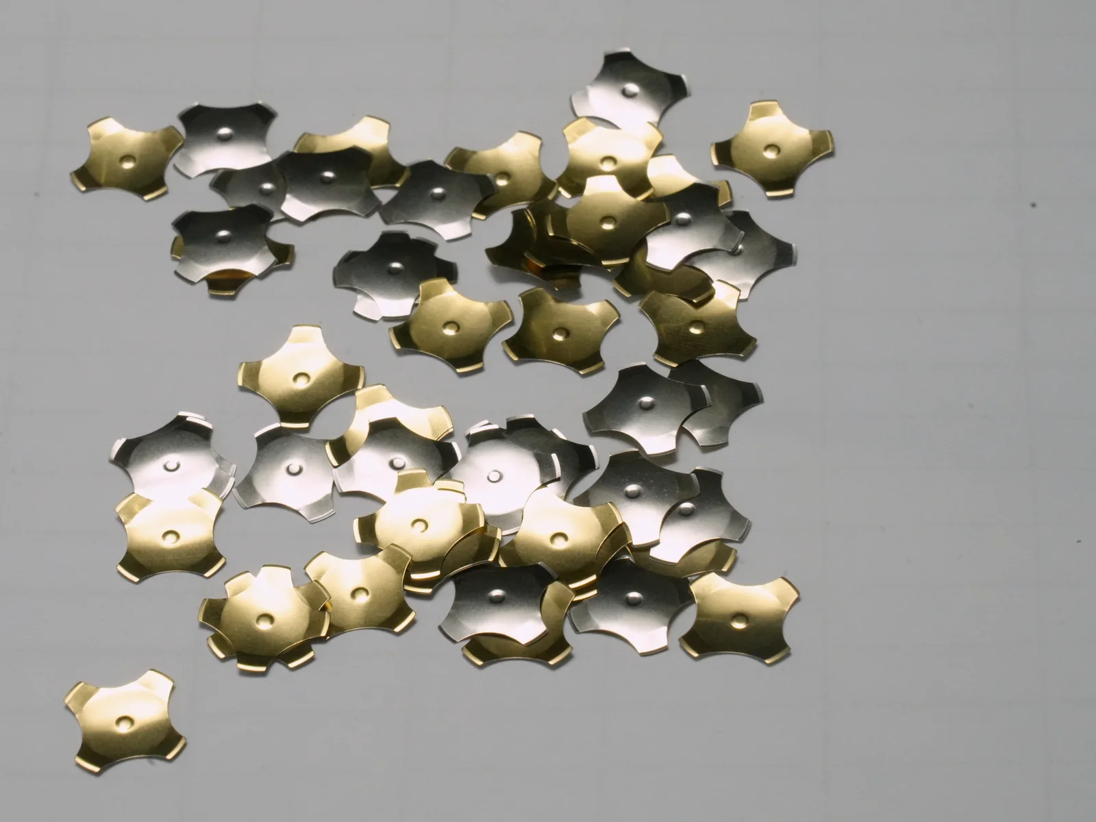 Loose four-leg metal domes photographed for JASPER material selection reference
