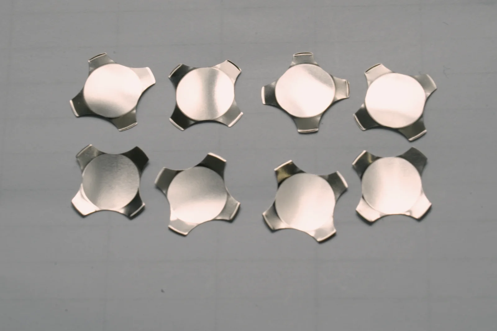 Eight four-leg metal domes arranged for geometry comparison