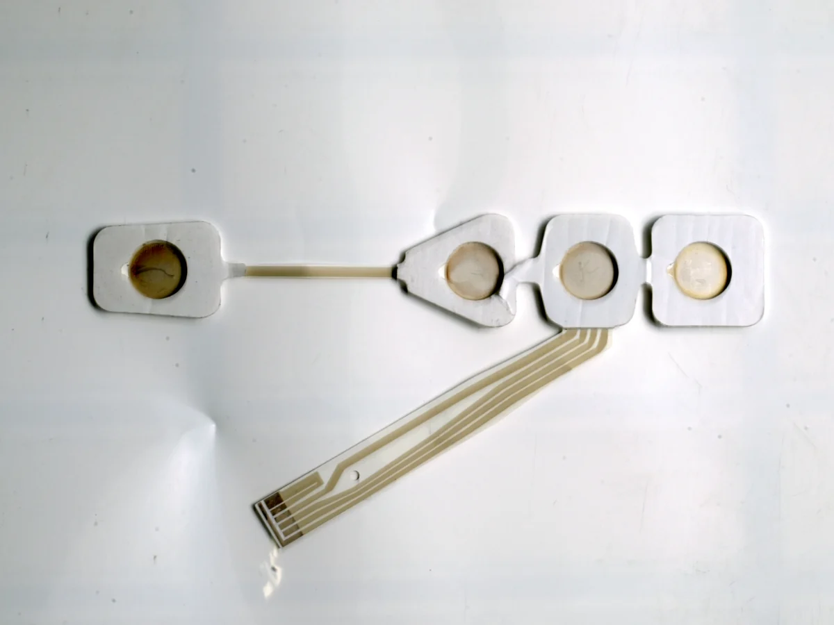rear contact and printed-tail construction of a flexible TENS and EMS electrode circuit