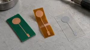 Rigid green, amber flexible and transparent film circuit samples with flat circular electrode areas and connection traces