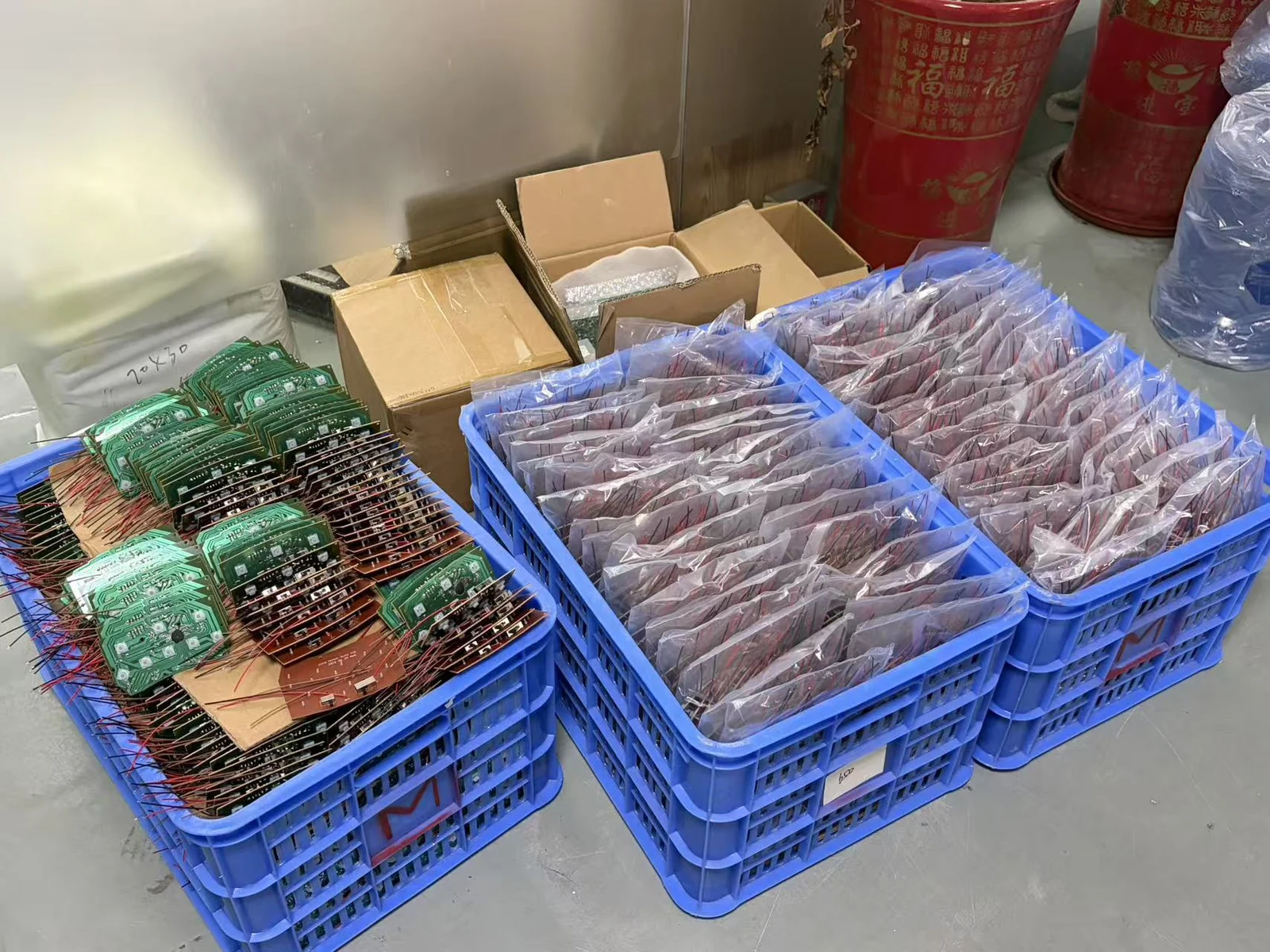 Circuit-board assemblies grouped in blue production containers