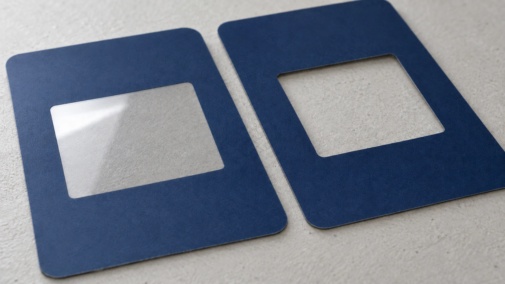Two blue graphic overlays, with a clear film window on the left and an open cutout on the right.